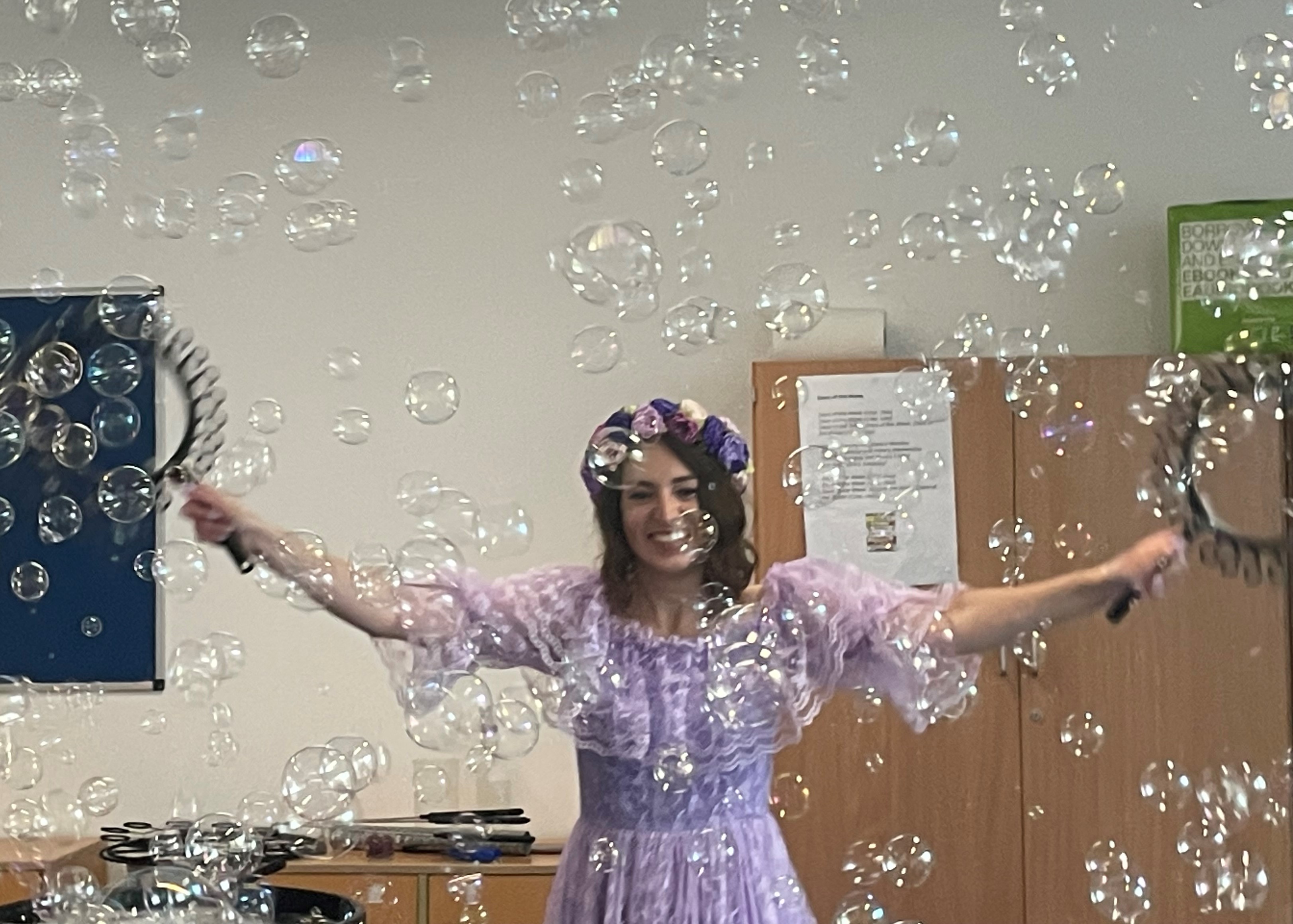 Smiling person surrounded by bubbles