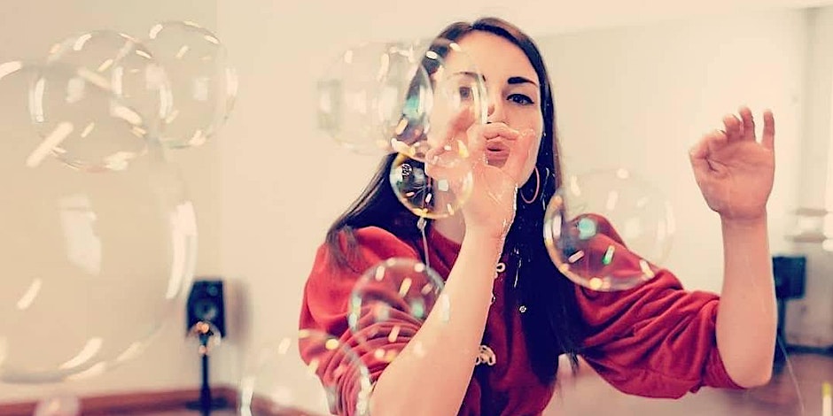 a photo of a lady making bubbles