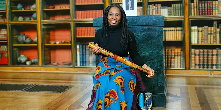 A lady sitting and holding a rainmaker