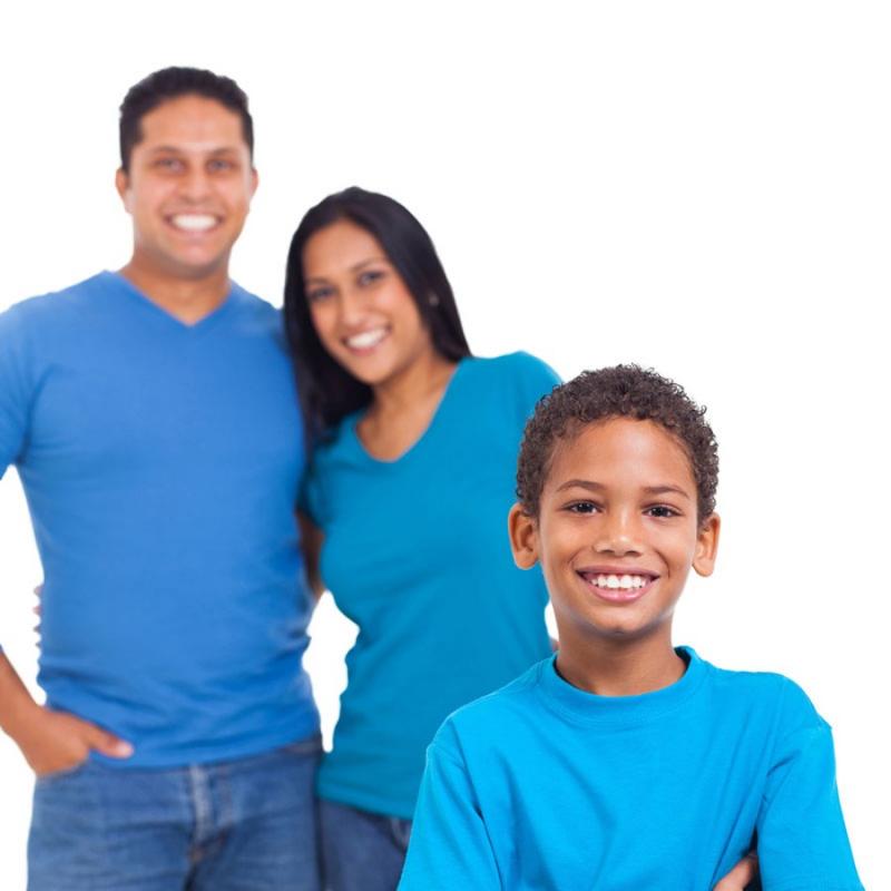 Couple standing behind child smiling