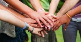 Group of hands in the middle of a circle