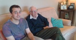 Two men sitting next to each other